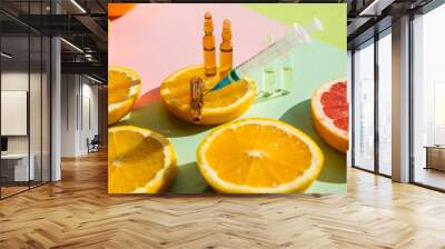 ampoules and Serum with Vitamin C. Organic cosmetics concept. Lemon, orange, grapefruits and ampoules on a light background. Injection of vitamin.Comineral supplement concept. Beauty products. Wall mural