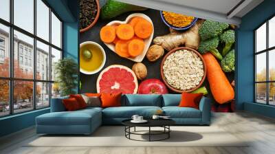 Border liver detox diet food concept, fruits, vegetables, nuts, olive oil, garlic. Cleansing the body, healthy eating. Top view, flat lay. Wall mural