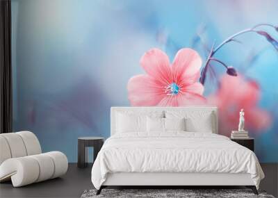 Border of delicate pink flax flowers on toned blue blurry background, beautiful natural art image. Selective soft focus Wall mural