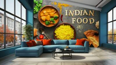 Chicken tikka masala spicy curry meat food in a clay bowl, rice and naan bread . Dark background, top view. Indian and British food. Wall mural