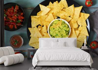 Corn chips nachos on a green blue wooden background. Top view. Mexican food. Wall mural