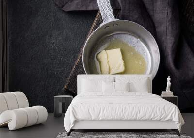 Melted butter on in iron pan Wall mural