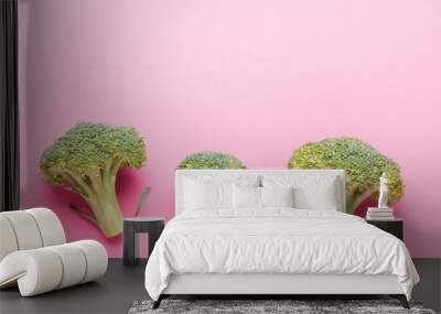 Broccoli vegetables on a pink background. Asparagus cabbage. Wall mural