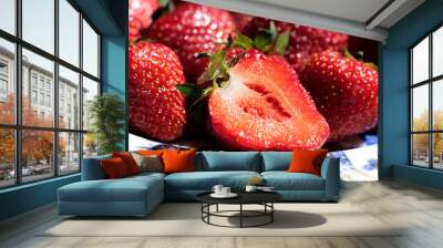 Close up of red fresh strawberries on a colourful plate and one sliced strawberry. Wall mural