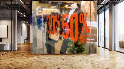 Shopping sale sign. Sign of sale shopping.discount sign on show window. Sale sign, symbol in clothes shop,The red announcement of a fifty-percentage discount on a glass show-window. Copy space Wall mural