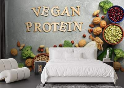 Vegan protein source : milk, legumes, pumpkin seeds, peas, nuts, avocado and broccoli on a gray concrete background. Top view, flat lay. Wall mural