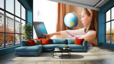 Young female distance teacher having video conference call with pupil using webcam. Online education and e-learning concept. Home quarantine, distance learning and working from home. Wall mural