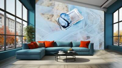 Above view of silver plate with shell inside and two wedding rings, with little diamond. Wedding ceremony in sea style. Decorated and stylish wedding at sea shore. Composition on stone, near water. Wall mural