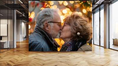 happy mature couple kissing in festive holiday love Wall mural