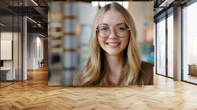 Head shot happy portrait caucasian girl in glasses young woman satisfied with ophthalmology services millennial blonde with healthy white toothy smile looking at camera confident model posing indoors Wall mural