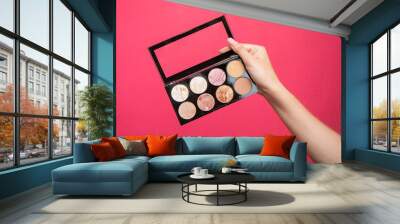 makeup artist showing eyeshadow palette. Wall mural