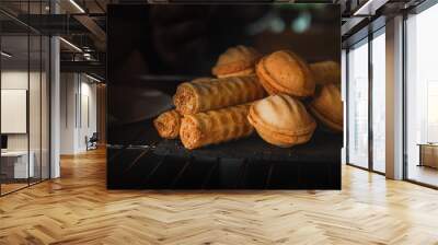 Tubes with condensed milk. A display case of a bakery or coffeeshop. Various types of mini desserts in a display case. Modern bakery or patisserie. A dessert of nuts with condensed milk. Wall mural