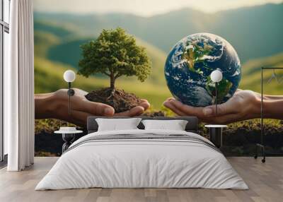 Two hands holding a small tree and the earth Wall mural