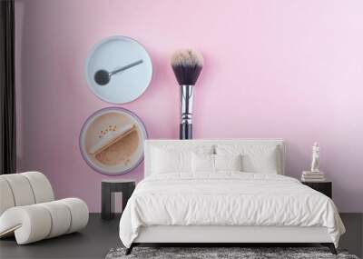 Beige face powder and brush for make up isolated on pink background with copy space, flat lay Wall mural