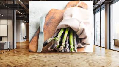 Bunch of raw organic asparagus spears on a board ready for cooking healthy diet food on a light grey marble background. Wall mural