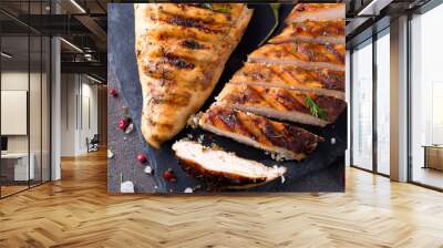 Grilled chicken fillets on slate plate on Gray concrete background. Healthy diet food concept, flat lay close up Wall mural