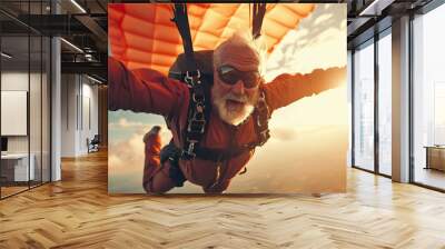 Elderly man jumping with a parachute. Wall mural