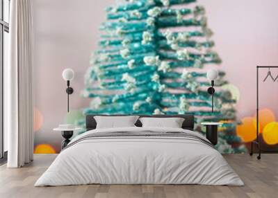 Miniature Christmas tree on a background of lights Wall mural