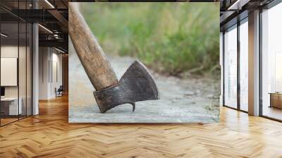 Old axe.Rusty axe for chopping firewood close-up.Countryside, village. Wall mural