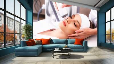 The procedure of rejuvenation of the female face rf-lifting photo. Skin care with radiofrequency lifting. Modern methods of skin aging treatment in cosmetology. Wall mural