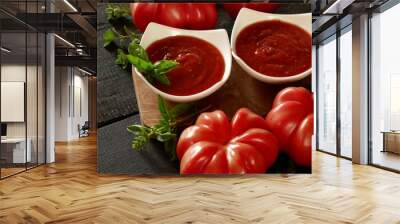 tomato ketchup.Tomato sauce.The recipe for ketchup. home made Tomato sauce and large  tomatoes with leaves on a black wooden background Wall mural