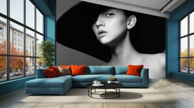 Portrait of a beautiful young girl in a hat, black and white photography in the studio Wall mural