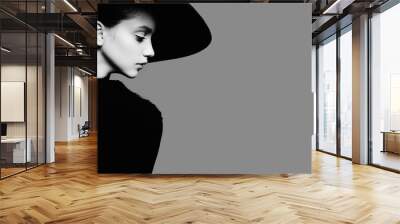 Portrait of beautiful girl in hat in profile, posing in studio, black and white photography Wall mural