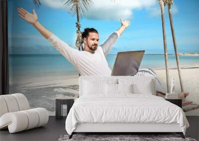 Businessman freelance on beach with laptop Wall mural