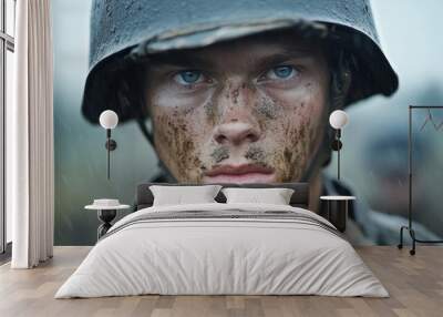 A soldier standing in the rain on a battlefield, his face covered in mud Wall mural