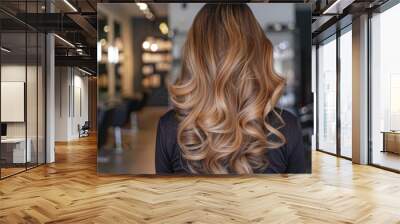 A woman with long, curly hair is standing in front of a salon Wall mural