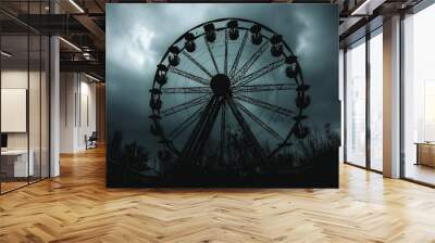 A silhouette of a Ferris wheel against a stormy sky. Wall mural