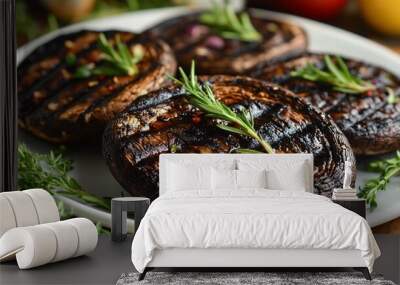 Close-up of grilled portobello mushrooms with rosemary and thyme on a white plate. Wall mural