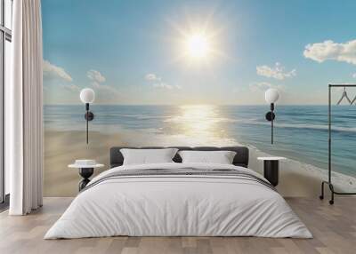 Sunny beach with clear blue water and white clouds. Wall mural