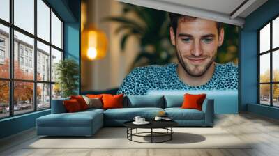 Happy Young Man Working on Laptop in Coffee Shop with Modern Cafe Vibes and Copy Space for Text Wall mural