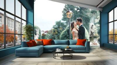 wedding couple kissing in the park in the rain Wall mural