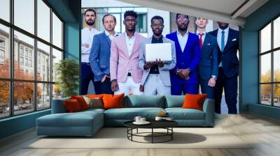 a group of seven successful business people men in stylish suits standing and looking proudly outdoors . teamwork and the multiethnic company concept Wall mural