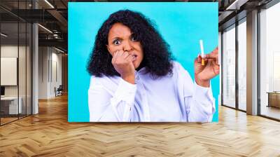 afro woman winning with addicted nicotine problems, stop smoking studio blue background Wall mural