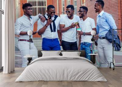 fashionable friends at a meeting. a group of five handsome African American men well-dressed businessmen having fun and communicating in the summer in the park Wall mural