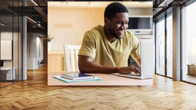 latin hispanic man freelancer using laptop studying online working from home Wall mural