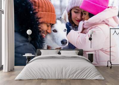 mixed race family in threesome spending new year holidays in park with their husky dog Wall mural