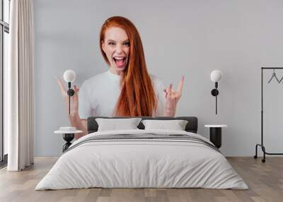 redhaired ginger woman in white cotton t-shirt showing rocks fingers Wall mural