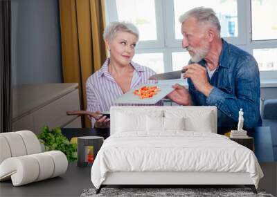 Senior couple preparing vegan dinner with organic fruits and vegatables Wall mural