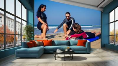 surf instructor and two girls beginner surfers on lesson in Goa India Wall mural