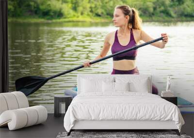 woman on sup sup board in nature at evening Wall mural