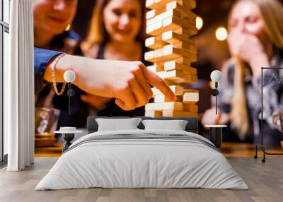 Young people have fun playing board games at a table . Wall mural