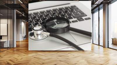 Laptop With Magnifying Glass And Stethoscope Wall mural