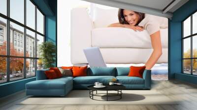 Spending a lazy day on the couch. a gorgeous young woman on a couch. Wall mural