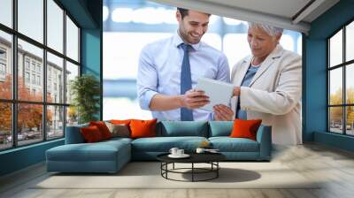 Thats quite impressive. A cropped shot of two colleagues discussing work on a tablet. Wall mural