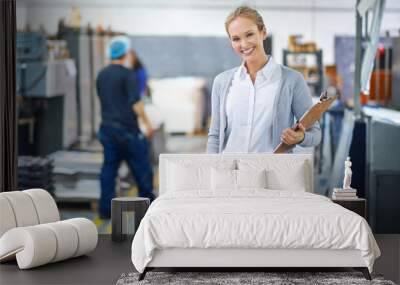 Focused on raising the bar each step of the way. A young manager looking confident while on the factory floor. Wall mural