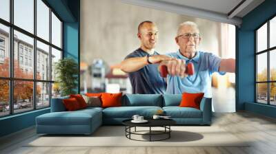 Forget about age, its time to engage. Shot of a senior man working out with the help of a trainer. Wall mural